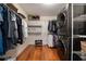 Well-organized laundry room features a stacked washer/dryer, ample storage shelves, and hardwood floors for a functional space at 1360 Edmund Ne Ct, Atlanta, GA 30306