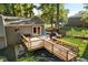 Back deck features wood railing, BBQ, outdoor seating, and access to backyard at 151 Quail Hollow Dr, Dallas, GA 30157