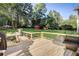 Spacious wooden deck with dark wicker seating and black metal railings overlooking a large, green backyard at 151 Quail Hollow Dr, Dallas, GA 30157