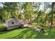 Spacious backyard with a deck, patio with comfortable seating, playground, and a lush green lawn, perfect for outdoor enjoyment at 151 Quail Hollow Dr, Dallas, GA 30157