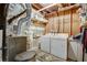 Unfinished basement space including washer and dryer hookups, hot water tank, and furnace at 151 Quail Hollow Dr, Dallas, GA 30157