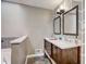 Bathroom featuring double sinks, decorative mirrors, and geometric patterned accent wall at 151 Quail Hollow Dr, Dallas, GA 30157
