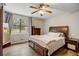 Well-lit bedroom with a ceiling fan, large window, and neutral décor at 151 Quail Hollow Dr, Dallas, GA 30157