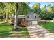 Two-story home with a charming front porch, well-maintained lawn, and mature trees at 151 Quail Hollow Dr, Dallas, GA 30157