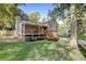 Beautifully landscaped front yard with a charming home, a spacious porch, and mature trees at 151 Quail Hollow Dr, Dallas, GA 30157