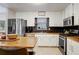 Well-lit kitchen with stainless steel appliances, butcher block countertops and white cabinetry at 151 Quail Hollow Dr, Dallas, GA 30157