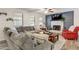 Comfortable living room with a stone fireplace, large sectional, and plenty of natural light at 151 Quail Hollow Dr, Dallas, GA 30157