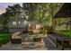 Inviting backyard patio with outdoor seating, a modern rug, and views of the home's exterior and well-kept lawn at 151 Quail Hollow Dr, Dallas, GA 30157