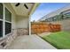 An outdoor patio with brick accents, a concrete floor, and a wooden fence, next to the green backyard at 1637 Short Shadow Ln, Snellville, GA 30078