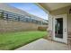 Backyard with green grass, stone retaining wall and sliding glass door at 1637 Short Shadow Ln, Snellville, GA 30078