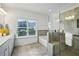 Bright bathroom features a glass shower, soaking tub, tile flooring, double sink vanity, and natural light at 1637 Short Shadow Ln, Snellville, GA 30078