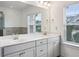 Bathroom featuring a dual vanity with ample storage, and a large window for natural light at 1637 Short Shadow Ln, Snellville, GA 30078