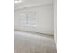 Bright, carpeted bedroom with large window at 1637 Short Shadow Ln, Snellville, GA 30078
