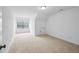 A large, bright bedroom with neutral carpet, white walls, and a window letting in natural light at 1637 Short Shadow Ln, Snellville, GA 30078