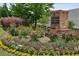 The landscaped entrance to Gladstone Landing displays seasonal flowers and plantings at 1637 Short Shadow Ln, Snellville, GA 30078