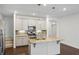 Bright and modern kitchen with granite countertops, stainless steel appliances, and island at 1637 Short Shadow Ln, Snellville, GA 30078