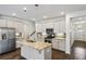 Bright kitchen features granite counters, stainless appliances, and an island with pendant lighting at 1637 Short Shadow Ln, Snellville, GA 30078