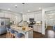 Well-lit kitchen with stainless appliances, an island with bar stools, and white cabinets at 1637 Short Shadow Ln, Snellville, GA 30078