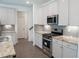 Well-lit kitchen with stainless appliances, granite countertops, and ample cabinet space at 1637 Short Shadow Ln, Snellville, GA 30078