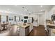 Open concept kitchen and living room with hardwood floors and white cabinetry at 1637 Short Shadow Ln, Snellville, GA 30078
