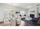 Bright living room with a decorative fireplace, sofa, glass table, area rug, and plenty of natural light at 1637 Short Shadow Ln, Snellville, GA 30078