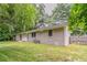 View of the home's exterior and spacious backyard with a lush green lawn and tree line at 2839 Long Way, Decatur, GA 30032