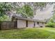 A fenced backyard with a lush green lawn and tree coverage for outdoor privacy at 2839 Long Way, Decatur, GA 30032