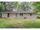 A spacious backyard with a white brick house and green lawn offers outdoor enjoyment at 2839 Long Way, Decatur, GA 30032