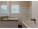 Bathroom featuring tiled walls and a tub with a granite vanity sink at 2839 Long Way, Decatur, GA 30032