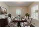 Elegant dining room with seating for eight, complemented by natural light and stylish decor at 2839 Long Way, Decatur, GA 30032