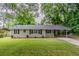 Charming brick home with a well-manicured front yard, carport, and cozy front porch at 2839 Long Way, Decatur, GA 30032