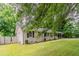 Landscaped front yard with a well-maintained lawn, mature trees, and charming brick accents at 2839 Long Way, Decatur, GA 30032