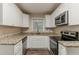 Updated kitchen with white cabinetry, granite countertops, and stainless steel appliances at 2839 Long Way, Decatur, GA 30032