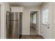 Bright kitchen features stainless steel refrigerator and convenient access to the backyard at 2839 Long Way, Decatur, GA 30032