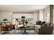 Open-concept living space with modern furniture, and white kitchen in the background at 1924 Logan Se Ln, Conyers, GA 30094