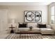 Inviting living room featuring a comfortable couch, stylish artwork, and plenty of natural light creating a cozy atmosphere at 1924 Logan Se Ln, Conyers, GA 30094