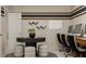 Stylish home office featuring a central table, comfortable seating, and practical wall-mounted organizers at 1924 Logan Se Ln, Conyers, GA 30094
