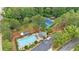 Aerial view of a community pool and tennis courts surrounded by trees at 200 Creek Run Ct, Alpharetta, GA 30005