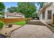 Backyard with a stone patio, wooden deck, and fenced-in lawn at 200 Creek Run Ct, Alpharetta, GA 30005