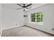 Bedroom featuring carpeted floors, a ceiling fan, and natural light from one window at 200 Creek Run Ct, Alpharetta, GA 30005