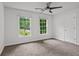Bedroom featuring carpeted floors, a ceiling fan, and natural light from two windows at 200 Creek Run Ct, Alpharetta, GA 30005