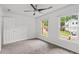 Bright bedroom with carpeted floors, a ceiling fan, and natural light from two windows at 200 Creek Run Ct, Alpharetta, GA 30005