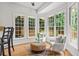 Cozy breakfast nook filled with natural light from the large windows and charming decor at 200 Creek Run Ct, Alpharetta, GA 30005