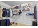 Organized walk-in closet with clothing racks, shelves, luggage, and shoe storage at 200 Creek Run Ct, Alpharetta, GA 30005
