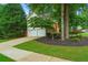 Home exterior with a driveway, two-car garage, and landscaped yard at 200 Creek Run Ct, Alpharetta, GA 30005