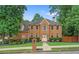 Charming two-story brick home featuring a manicured lawn and lush landscaping, and a welcoming front entrance at 200 Creek Run Ct, Alpharetta, GA 30005