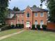 Classic two-story brick home featuring symmetrical windows and a well-manicured front lawn in a suburban setting at 200 Creek Run Ct, Alpharetta, GA 30005