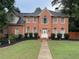 Charming brick home featuring a gabled roof, symmetrical windows, and a meticulously maintained front lawn at 200 Creek Run Ct, Alpharetta, GA 30005