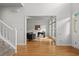 Spacious foyer with hardwood floors and staircase, leading to a home office with ample natural light at 200 Creek Run Ct, Alpharetta, GA 30005
