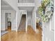 Inviting entryway featuring hardwood floors, staircase, and a view into the living spaces with abundant natural light at 200 Creek Run Ct, Alpharetta, GA 30005